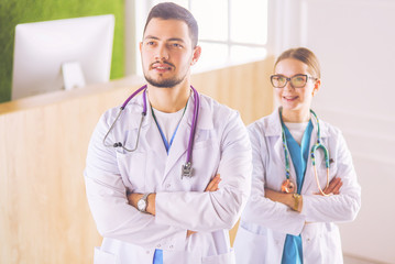 A view of a happy medical team of doctors, men and woman, isolated on white background