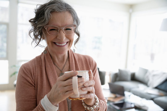 Portrait happy senior woman drinking coffee
