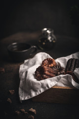 Canneles desserts in wooden box dark and moody food photography