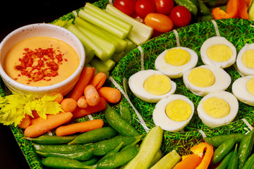 Boiled eggs with vegetable platter and dipping sauce, ranch.
