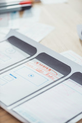 Fototapeta premium Selective focus of ui planning for mobile app on wooden table