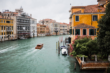 vaporetto floating on canal bear ancient buildings in Venice, Italy - obrazy, fototapety, plakaty