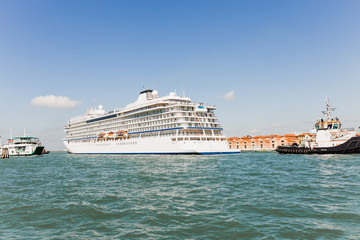Fototapeta na wymiar Cruise Ship and ships floating on river in Venice, Italy