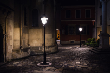 illuminated street at night. Old european city - obrazy, fototapety, plakaty