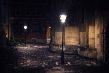 Rainy night in old European city with lanterns - 316194221