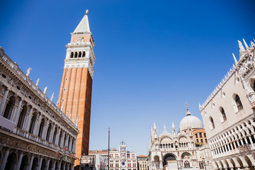 Fototapeta na wymiar low angle view of Saint Mark Bell Tower and Cathedral Basilica of Saint Mark in Venice, Italy