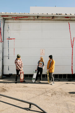 Skateboarders Hanging Out In Parking Lot