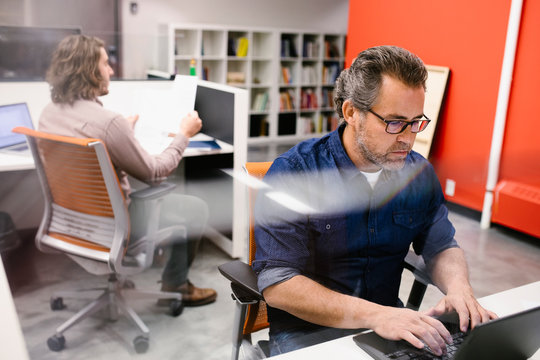 Businessman Working At Laptop In Office