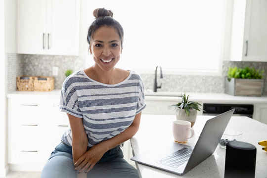 Portrait Confident Woman Working From Home At Laptop In Kitchen