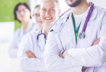 Fototapeta premium Happy medical team comprising male and female doctors smiling broadly and giving a thumbs up of success and hope