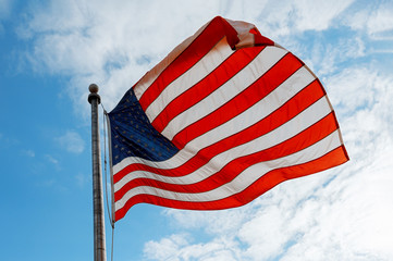 American flag on the blue sky