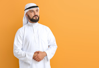 Handsome Arab man on color background