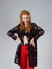 young girl with long red hair on a gray background