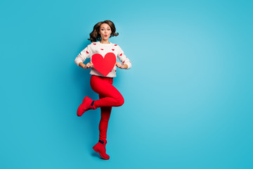 Fototapeta na wymiar Full length body size view of nice attractive lovely cheery playful flirty girl jumping holding in hands heart having fun sending air kiss isolated on bright vivid shine vibrant blue color background
