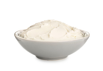 Fototapeta na wymiar Bowl with tasty cream cheese on white background