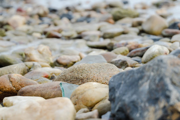 Background of pretty pebbles stone on the beach .