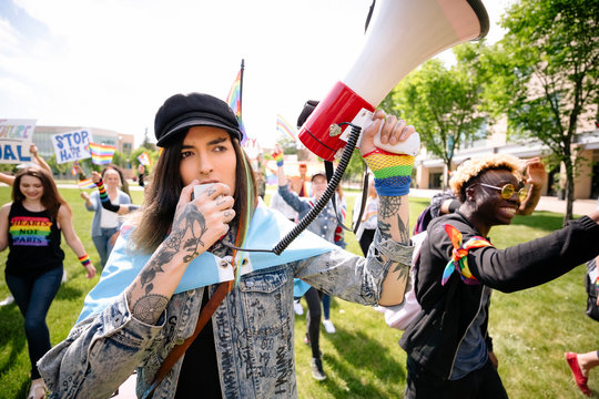 Student leading gay pride rally using megaphone
