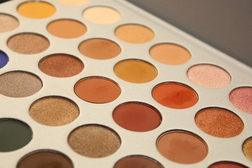  makeup palettes on wooden background, closeup