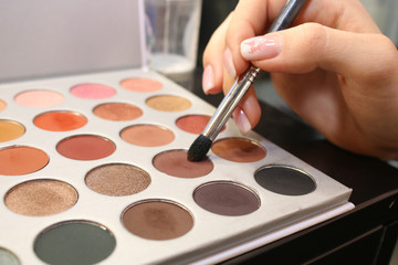  makeup palettes on wooden background, closeup