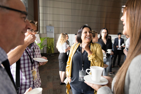 Business people talking, networking during conference coffee break