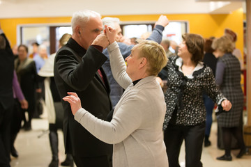Dancing for pensioners.A group of elderly people are dancing in a nursing home.