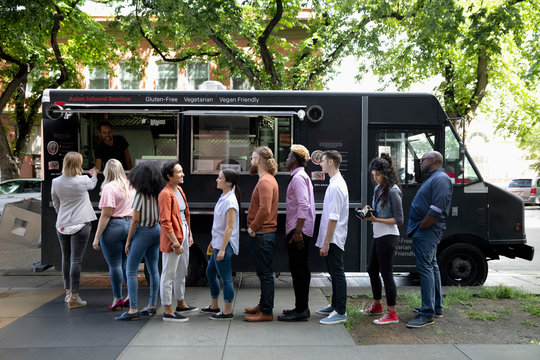 Customers waiting in queue outside Food truck
