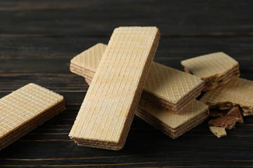 Sweet wafer biscuits on wooden background, close up