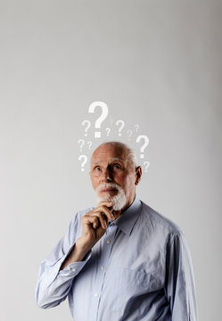 Old man and question marks. Confused old man.