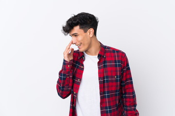 Young Argentinian man over isolated white background smiling a lot