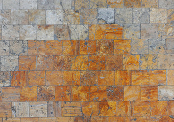 Gray-orange tiles on the floor. Vintage. Cracked tile. Background and texture of tiles.