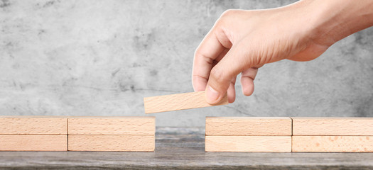 Hand arranging wood block . Business concept growth .