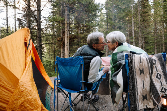 Affectionate senior couple kissing at campsite