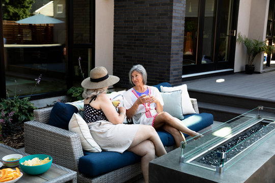 Senior Women Friends Drinking Margaritas On Summer Patio