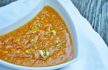 A dessert dish of moong dal halwa lentil pudding at an Indian restaurant