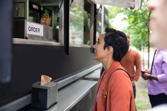 Businesswoman ordering at Food truck