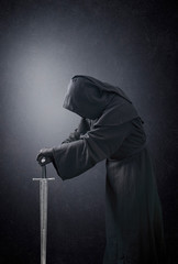 Ghostly figure with long medieval sword in the dark