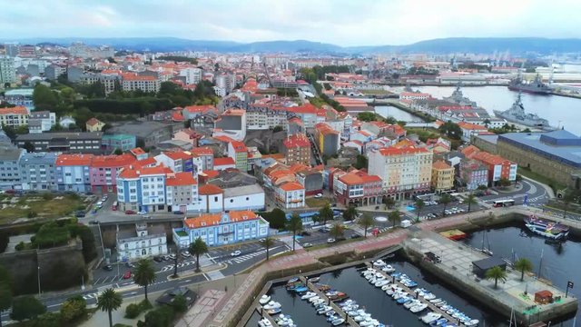 Aerial view of a calm marina with the city of Ferrol, Spain, in the background