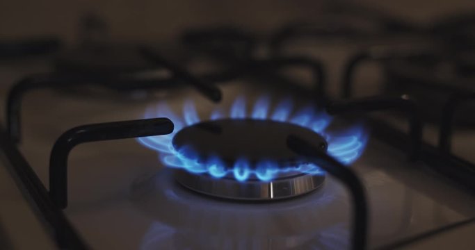 Gas stove ignition detail closeup view, slow motion