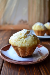 Home cooked muffins on a brown wooden table in the kitchen. Copy space.