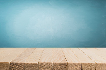 Heavenly blue wall and empty turquoise table.