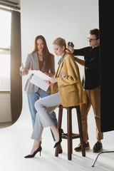 producer talking with model and hairstylist doing hairstyle on backstage