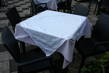 outdoor restaurant, empty table with white tablecloth