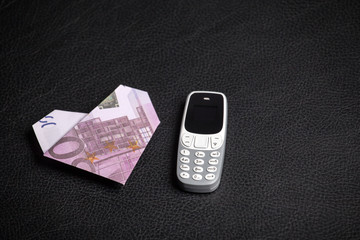 mobile phone money leather background 