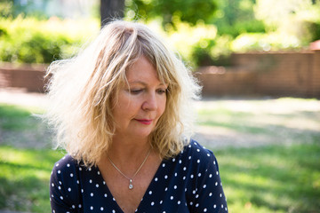 Beautiful sad woman outside. Portrait mature woman.