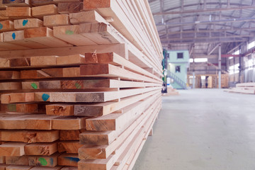 Warehouse or factory for sawing boards on sawmill indoors. Wood timber stack of wooden blanks construction material. Logging Industry.
