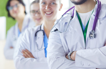 Group of doctors and nurses standing in the hospital room