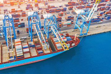 Large container ship in port. front view, unloading loading cargo. Aerial view.