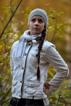 beautiful Russian girl in a gray hat in autumn