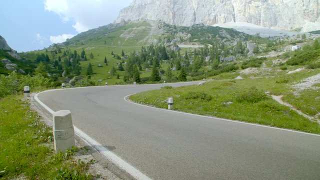 Empty winding mountain road with smooth asphalt. Steadicam forward shot. High quality 4k prores.