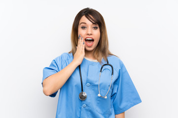 Young nurse woman over white wall with surprise and shocked facial expression